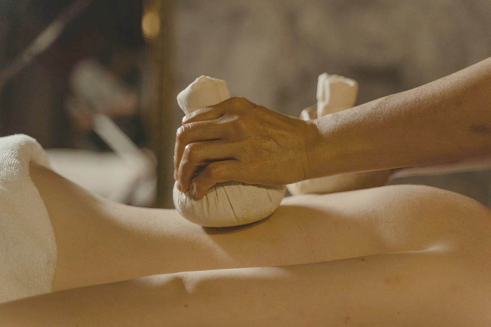 Warming with a herbal bolus, one of the Kerala treatments taught on the course