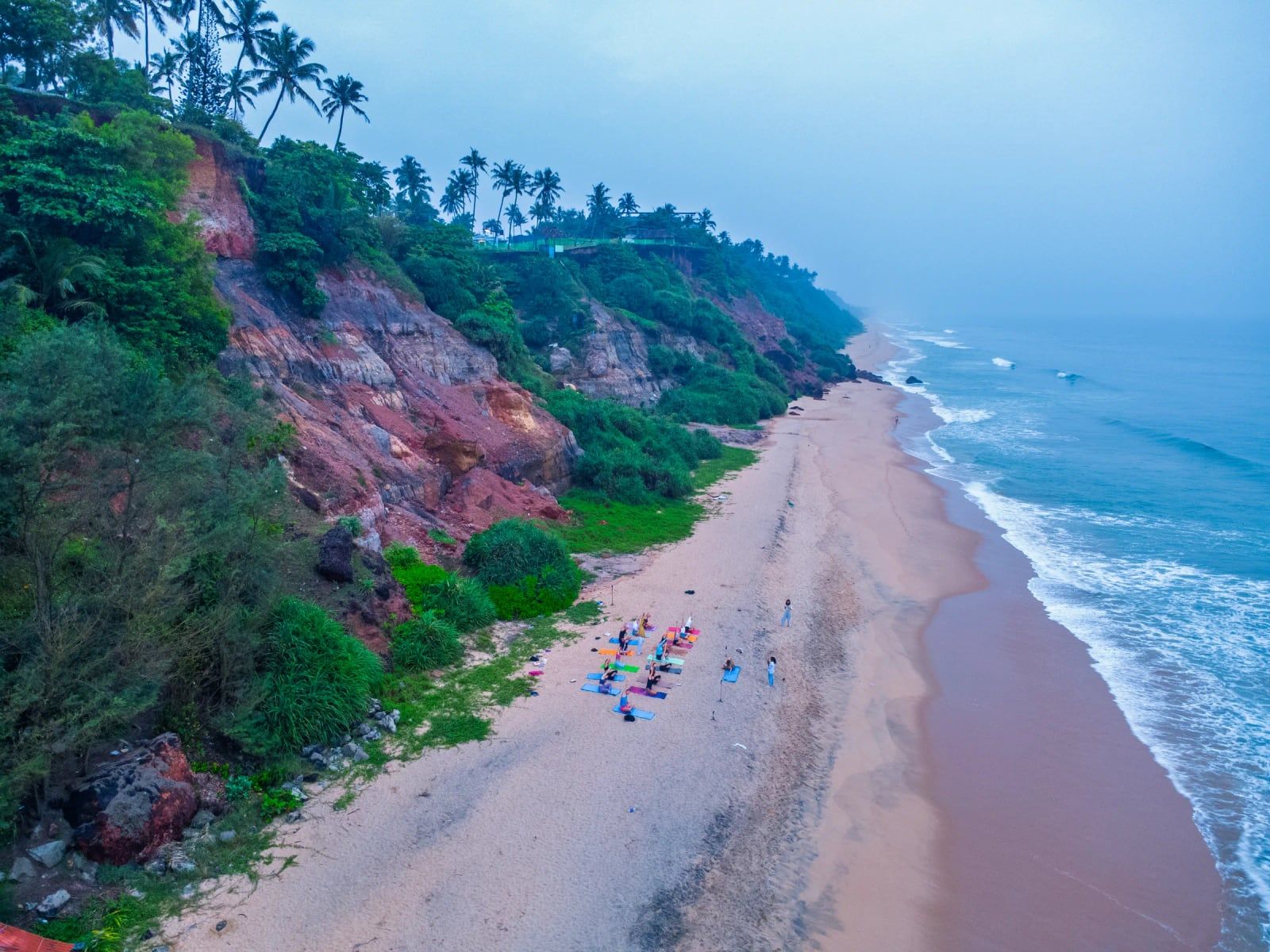Varkala cliff and beach from above, morning practice on the sand